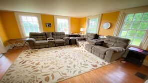 Relax in this inviting living room with a large sofa, coffee table, and area rug.