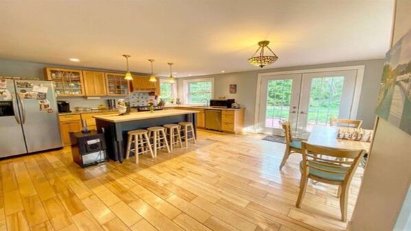 Enjoy meals in the kitchen with a central island and dining area offering a view of the outdoors.