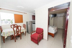 Cozy living space with a dining area, kitchenette, and separate sleeping area.