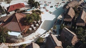 A coastal resort with beach access, multiple bungalow-style accommodations, and a pool area.