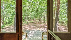 A wooden staircase leading into a forested area with a view through three windows. - Blanchard Cabin in the Woods ~ close to caverns (Mountain View)