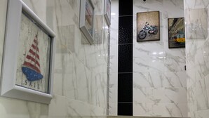 A marble staircase in a hotel lobby with framed artwork on the walls. - Lee Luxury Home USM Penang (George Town)