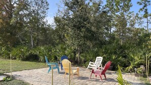 An outdoor seating area with chairs and a small water feature. - Private studio; big outdoor space  (Orlando)