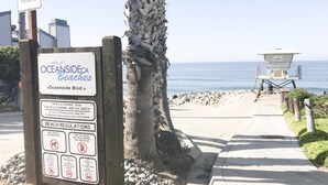 A beach sign with regulations and a lifeguard tower in the background. - ☀️HUGE Beach House!☀️3 blocks to BEACH🏖Ocean View🏝 3 BR/2.5BA (Oceanside)