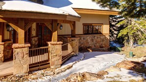 A wooden cabin with a stone foundation, a covered porch, and a snow-covered roof. - 4 Bdr/4.5Bath-Steps to lifts and Stein Eriksen (Park City)