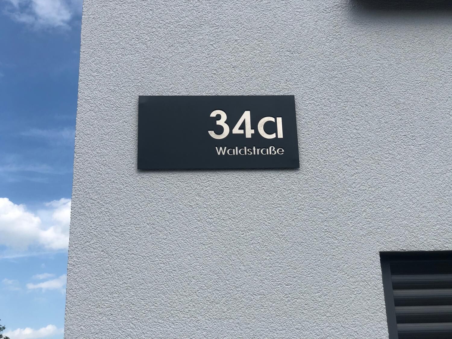 A building with a sign indicating the address "34 CI Waldstraße".