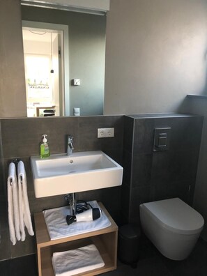 Shower, rainfall showerhead, hair dryer, towels