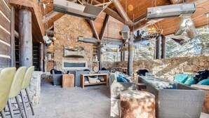 A rustic outdoor seating area with stone walls, wooden beams, and a stone fireplace. - SPECIAL! Ritz-Carlton Bachelor Gulch 2BR&2BA Residence INSIDE hotel adj to Lift! (Avon)