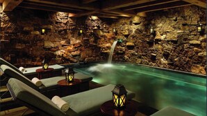 A spa area with a stone wall, a small waterfall, and lounge chairs with lanterns. - SPECIAL! Ritz-Carlton Bachelor Gulch 2BR&2BA Residence INSIDE hotel adj to Lift! (Avon)