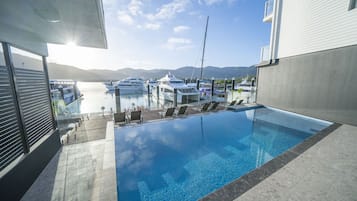 Outdoor pool, a heated pool, open 6:00 AM to 10:00 PM, pool loungers