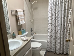 Combined shower/tub, hair dryer, towels, soap