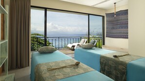 A balcony with two beds, a view of the sea, and a hanging tapestry. - Adiwana Warnakali Resort (Penida Island)