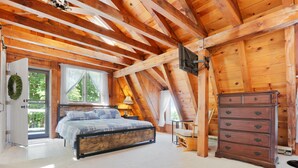 A bedroom with a wooden ceiling, a bed, a dresser, and a window with curtains. - Whole House, Scenic Post and Beam Home Overlooking Canandaigua Lake! Sleeps 10 (Canandaigua)