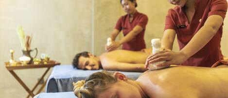 A massage therapy room with two clients receiving massages.