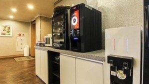 A kitchen with a refrigerator, microwave, and coffee machine. - Yangji Park Hotel (Changwon)