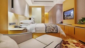 A hotel room with a bed, bedside table, TV, and a sofa. - Zijing International Hotel (Enshi)