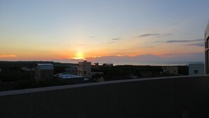 A sunset over a residential area with buildings and a clear sky. - Hong Hu Ju Captain Sung's House (Baisha)