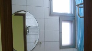 A bathroom with a sink, toilet, and a window. - Hong Hu Ju Captain Sung's House (Baisha)