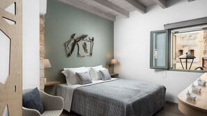 A bedroom with a bed, a chair, a nightstand, and a window. - Boutique Home-Splantzia-Roof Garden-2min Harbor (Chania)