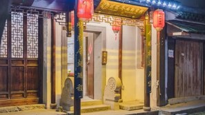 A traditional Chinese building with wooden doors and a tiled entrance. - Floral Hotel Rainview Pavilion (Suzhou)