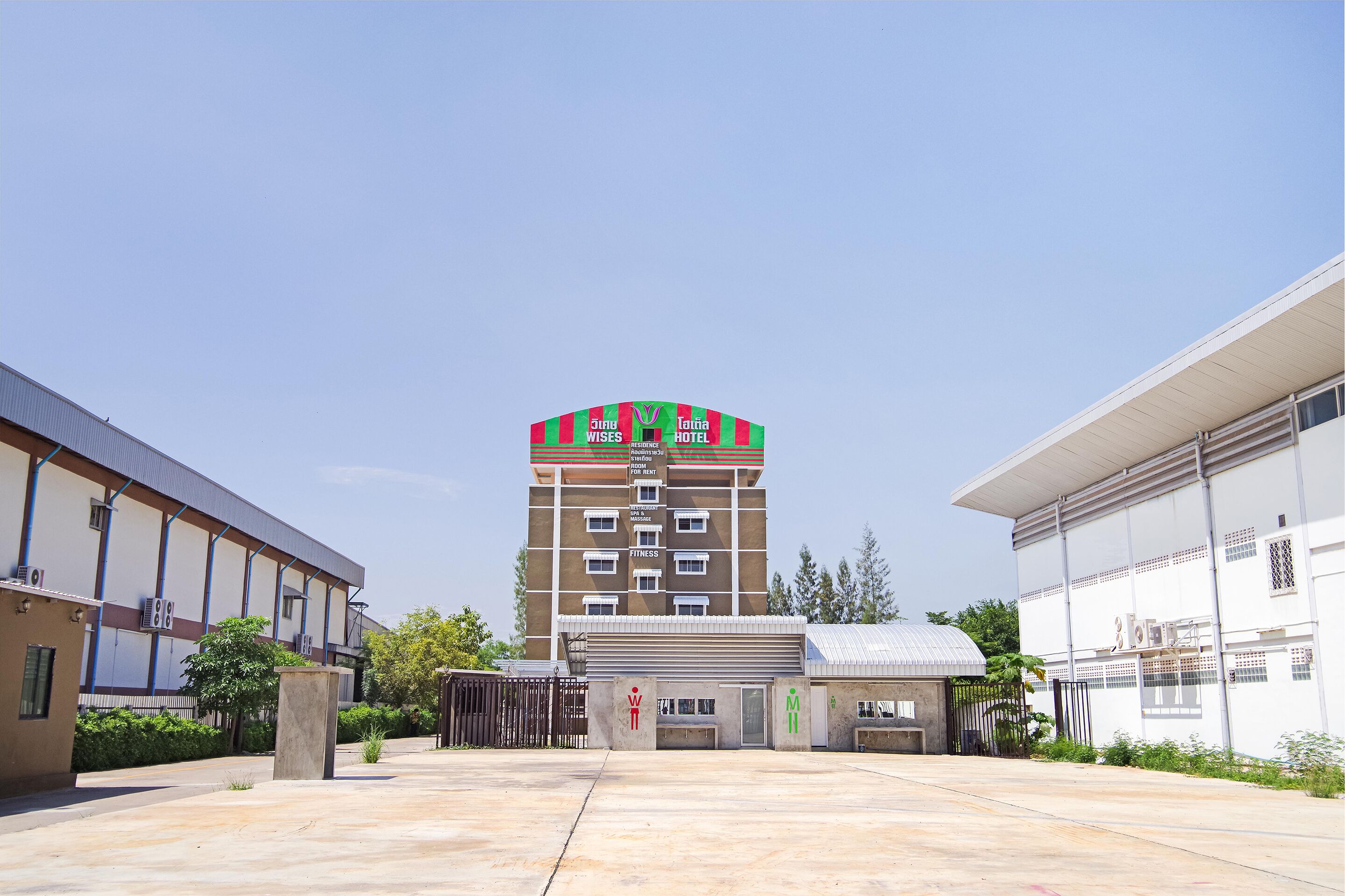 A multi-story building with a sign indicating it is a hotel.