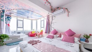 A bedroom with a large bed, a sitting area with a chair, a bathtub, and a window with a view. - Floral Hotel Jiu Qi Yin Ju Dunhuang (Jiuquan)
