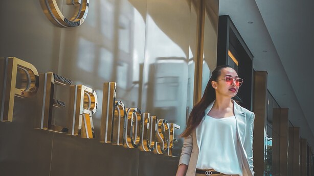 A person walking past a building with a large sign that reads "PER HOUSE". - The Upper House Hotel (Simpang Ampat)