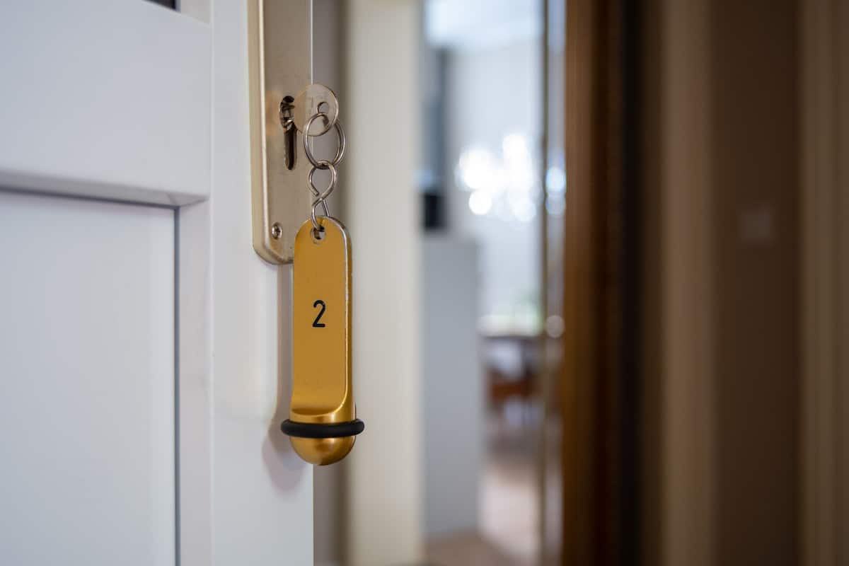 A door with a keyhole and a keychain with a numbered tag.
