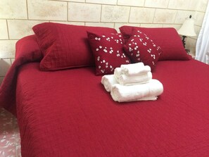 Restful retreat with a neatly made bed and plush towels.