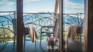 Un balcon doté de meubles en osier et offrant une vue sur les montagnes.
