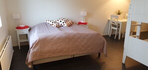 A neatly arranged bedroom with a bed, two bedside tables, a desk, and a chair. - Södersens Golf Lodge (Billesholm)