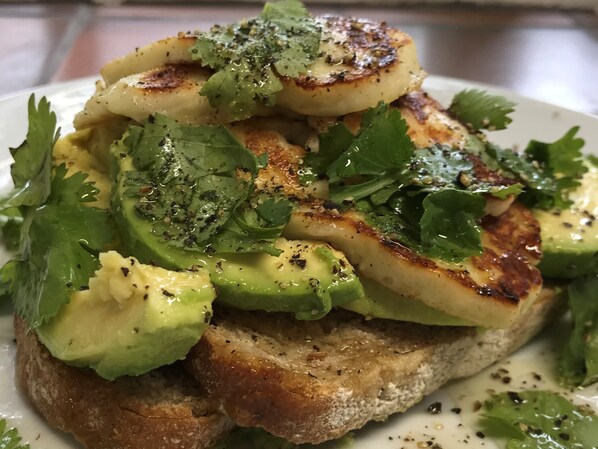 A plate of food with grilled potatoes, avocado, and cilantro. - The Old Dower House (Whitchurch)