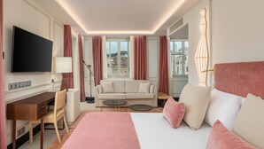 A hotel room with a bed, a desk, a sofa, and a television. - Room Mate Gran Filippo I, Roma-Fontana di Trevi (Rome)