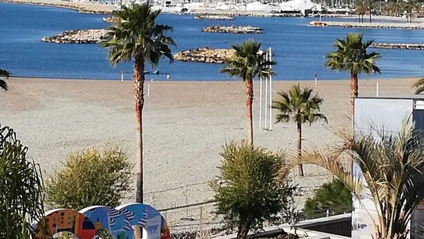 A coastal cityscape with a beach, palm trees, and a marina. - VILLENEUVE LOUBET BEACH 5MN FROM BEACHES, 2 BEDROOMS 2 BATHROOMS SEA VIEW, TENNIS  (Villeneuve-Loubet)
