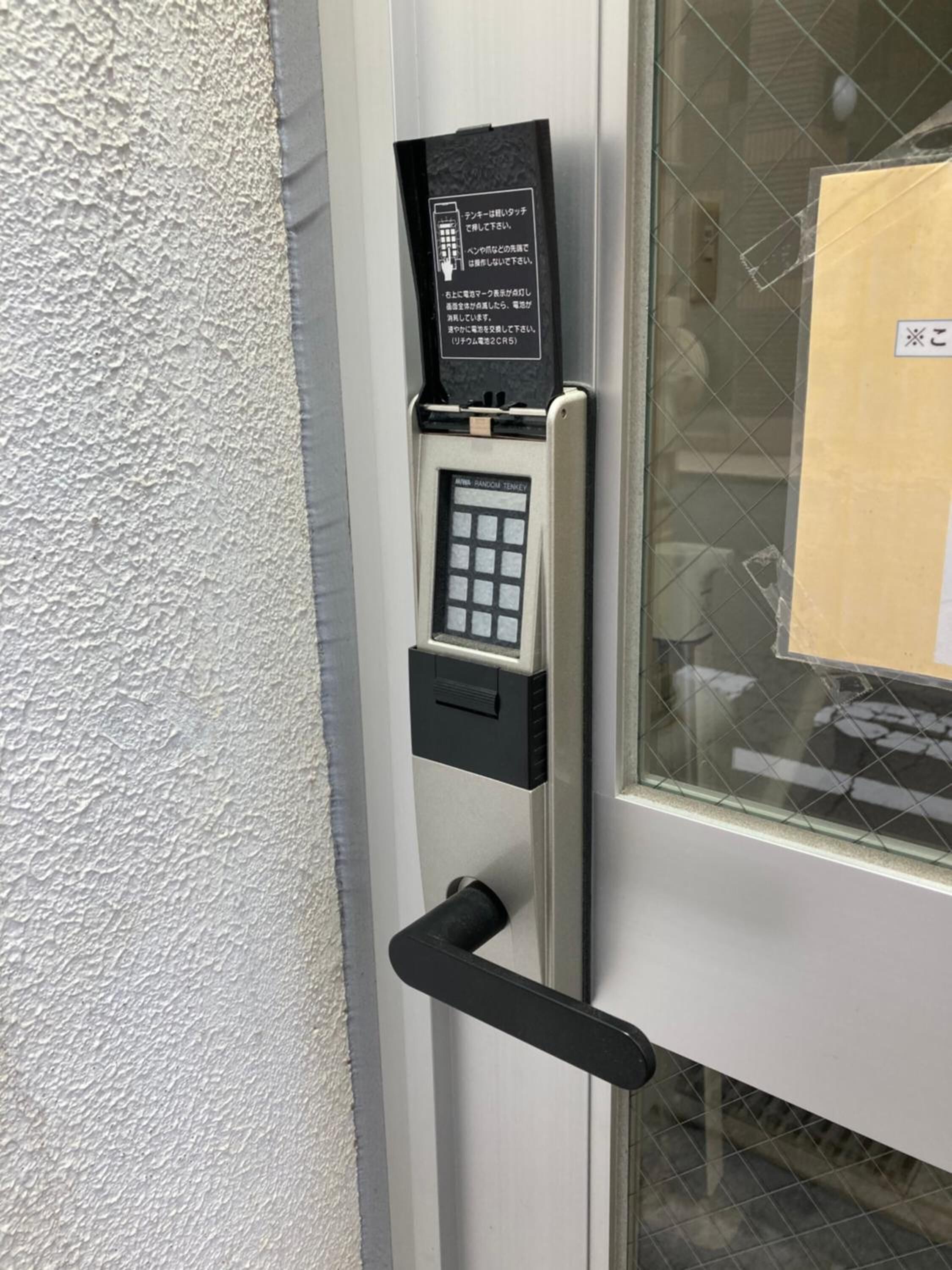 A door with a keypad lock and a card reader, suggesting a secure entry system.