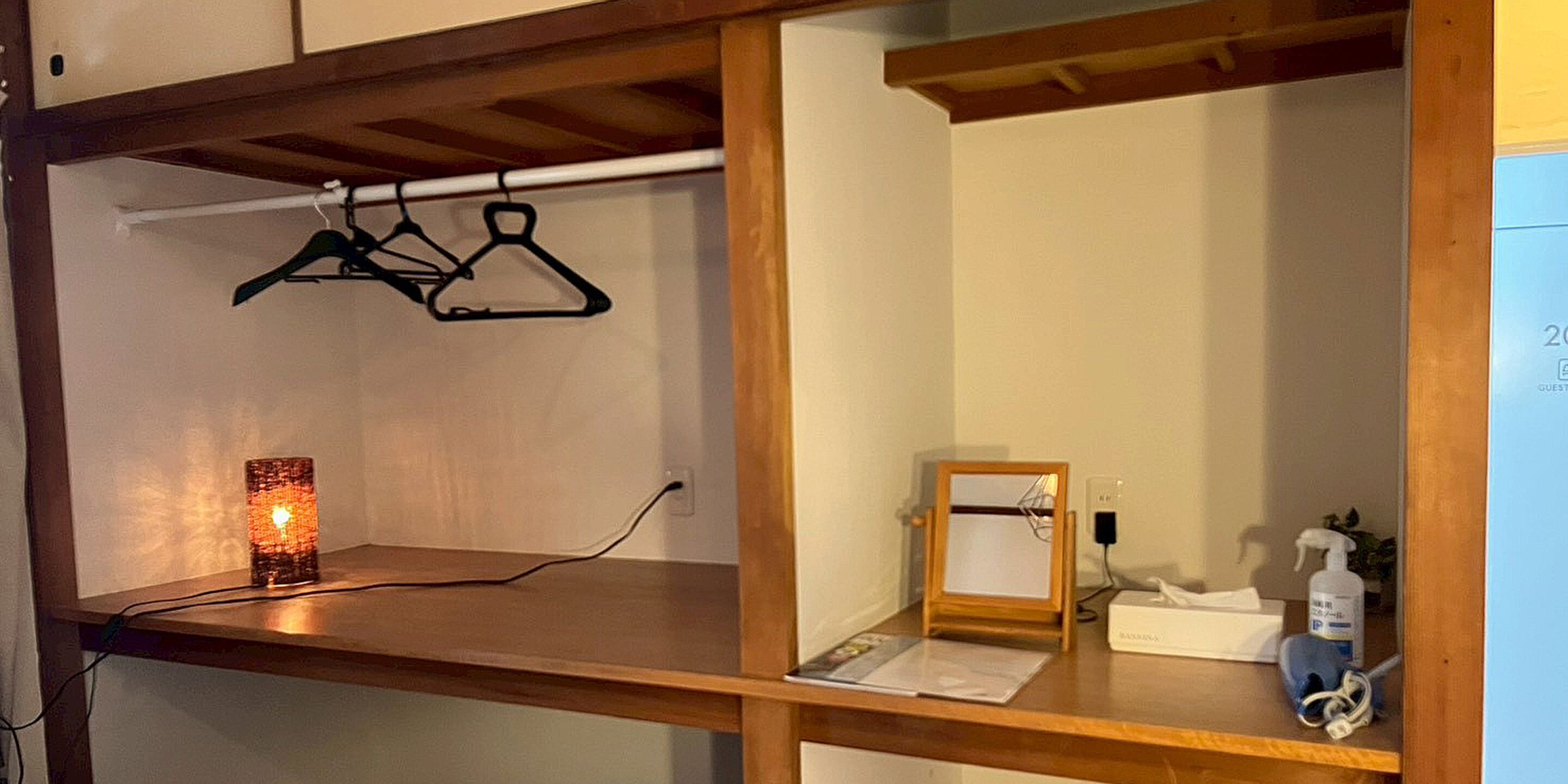 A wooden desk with a candle, a mirror, and a small box.