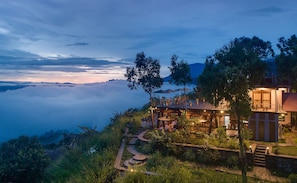 A hillside restaurant with outdoor seating overlooking a mountainous landscape. - Dream Cliff Mountain Resort (Beragala)