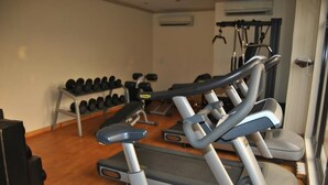 A gym with treadmills, dumbbells, and exercise equipment. - Casa Estrella Hotel (Abuja)