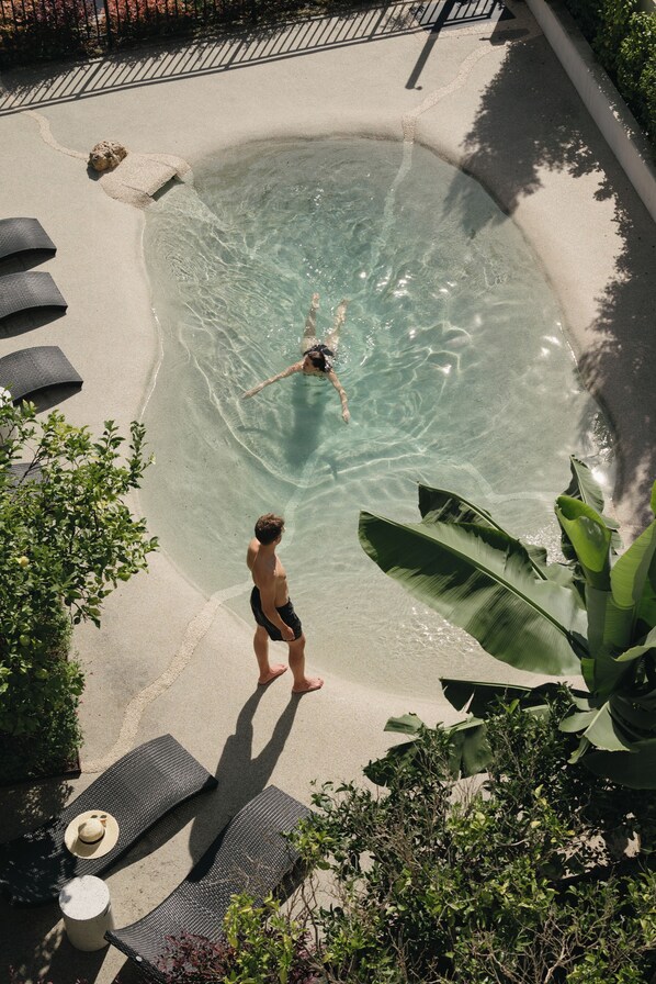 Outdoor pool, open 9:00 AM to 9:00 PM, pool umbrellas, pool loungers