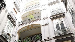 A multi-story building with balconies, arched windows, and visible utility lines. - Dimora Ruggiero (Naples)