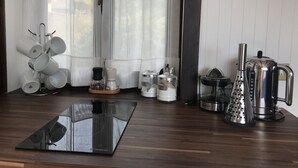 A kitchen with a coffee maker, grater, and mug rack. - LA PLAYA: Villa with a Private Beach and All-Inclusive Sports  (Pettenasco)