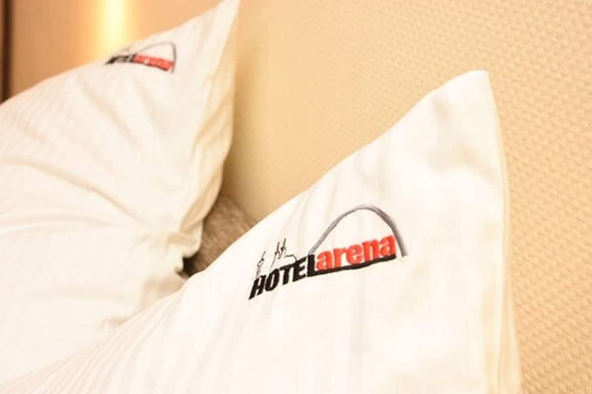 A pillow with the logo "HOTEL La Rena."