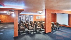 A conference room with rows of chairs, a projector screen, and a large window with a view of the Eiffel Tower. - Platinum Image Hotel (Elin Pelin)