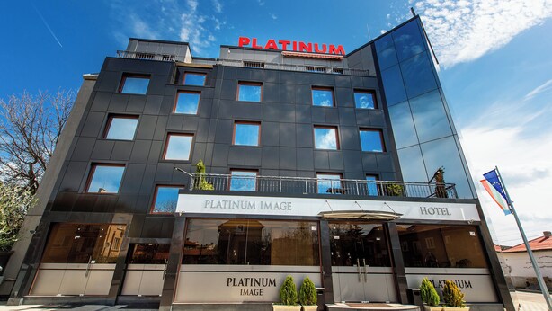 A modern hotel with a prominent 'Platinum Image' sign, multiple balconies, and a clear sky. - Platinum Image Hotel (Elin Pelin)