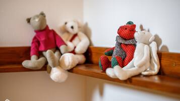A wooden shelf with three plush toys.