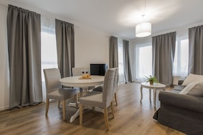 Deluxe Apartment | Living room | Flat-screen TV