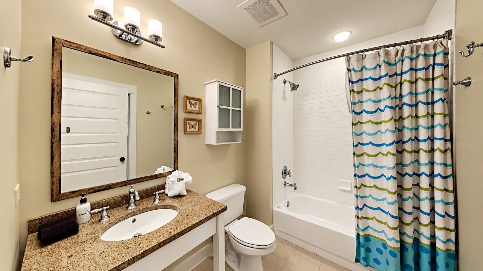 A bathroom with a sink, toilet, and bathtub.