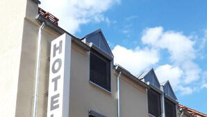 A hotel building with multiple windows and a sign indicating it is a "WEINERT HOTEL." - Hotel Weinert (Neubrandenburg)