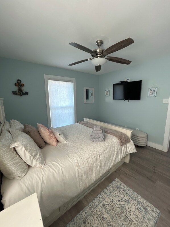 A bedroom with a bed, a ceiling fan, a TV, and a window. - 3 BR / 2 BA Beautiful Home w/ Loft or Office Space & Clear View of Beach (Gulf Shores)