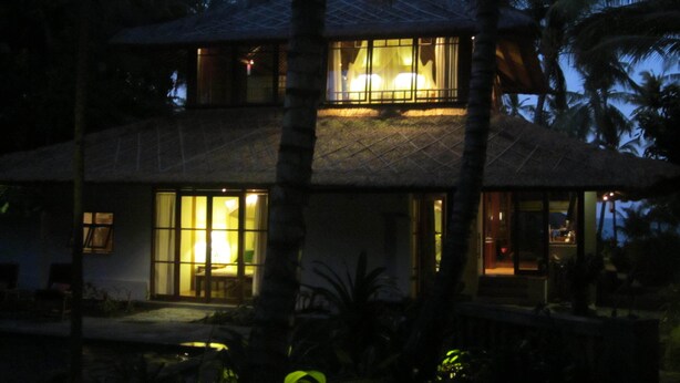 A two-story house with large windows and a thatched roof, surrounded by palm trees. - The Wantilan in Tejakula (Tejakula)